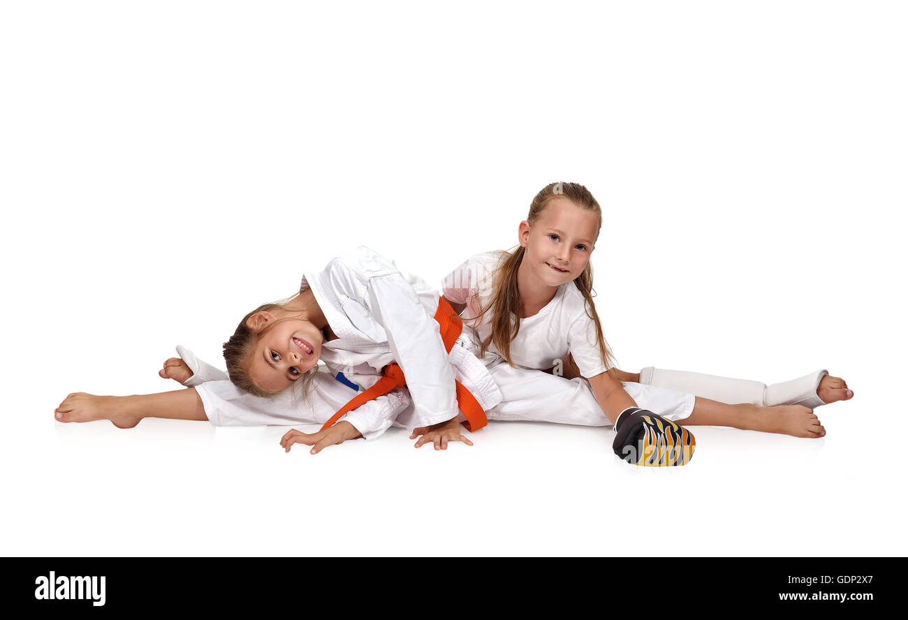 two karate girl sitting on the splits Stock Photo