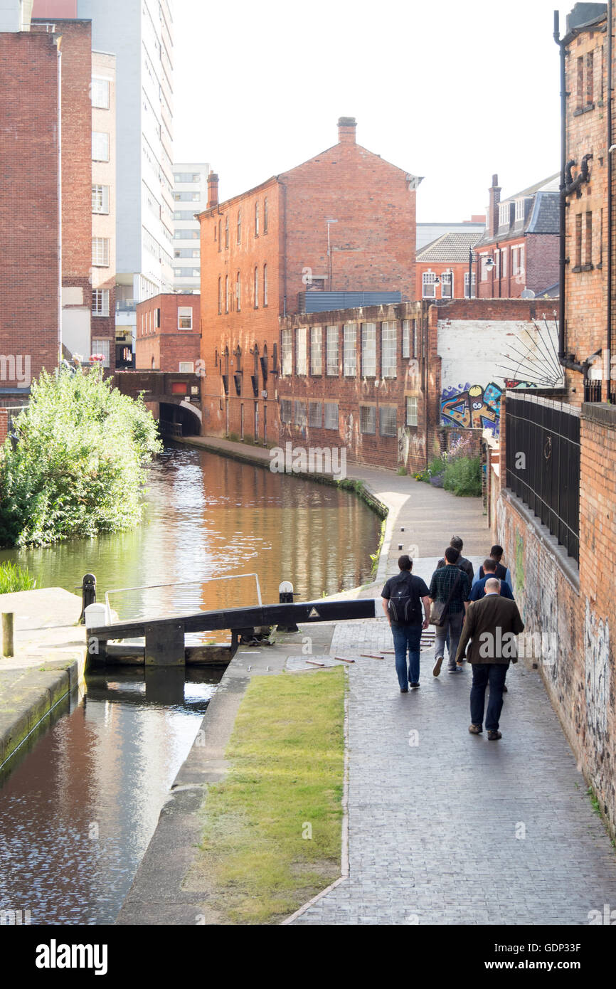 Men walking along a towpath beside a canal in the Jewellery Quarter, Birmingham. Stock Photo