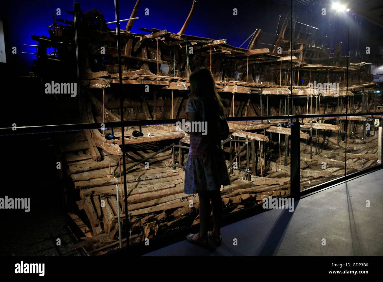 A young visitor looks at the remains of Henry VIIIss favourite ship the Mary rose during their unveiling at a press preview exactly 471 years since its sinking and following 34 years of conservation at the Portsmouth Historic Dockyard, HM Naval Base, Portsmouth. Stock Photo