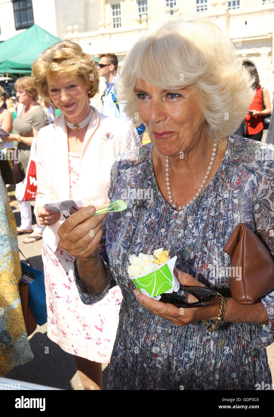 The Duchess of Cornwall enjoys an ice cream during a visit with her husband, the Prince of Wales, to the Taste of the West's 25th anniversary Food Fair in the grounds of Exeter Cathedral on the second day of their annual visit to the South West. Stock Photo