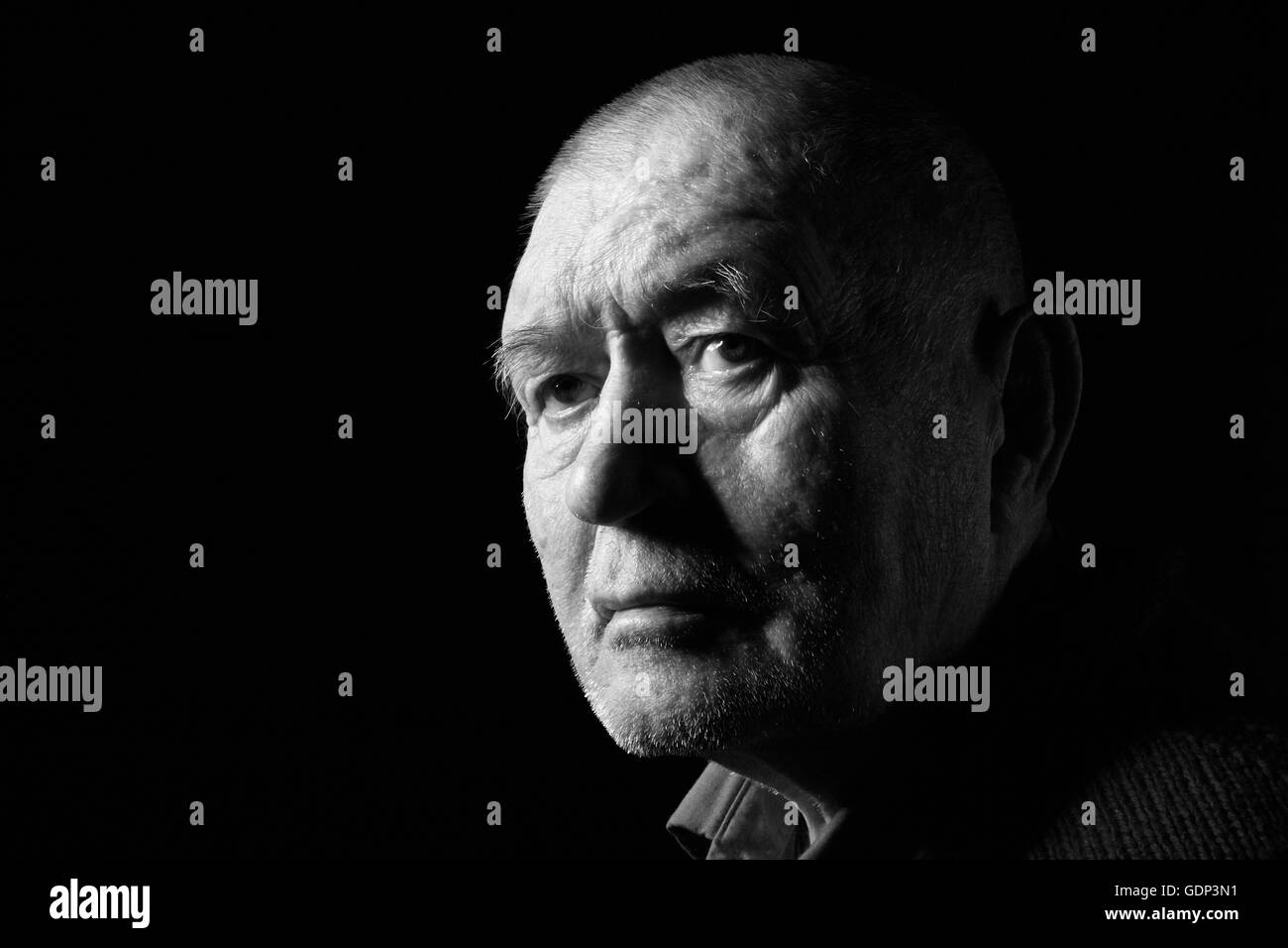 serious old man senior on black background, monochrome Stock Photo