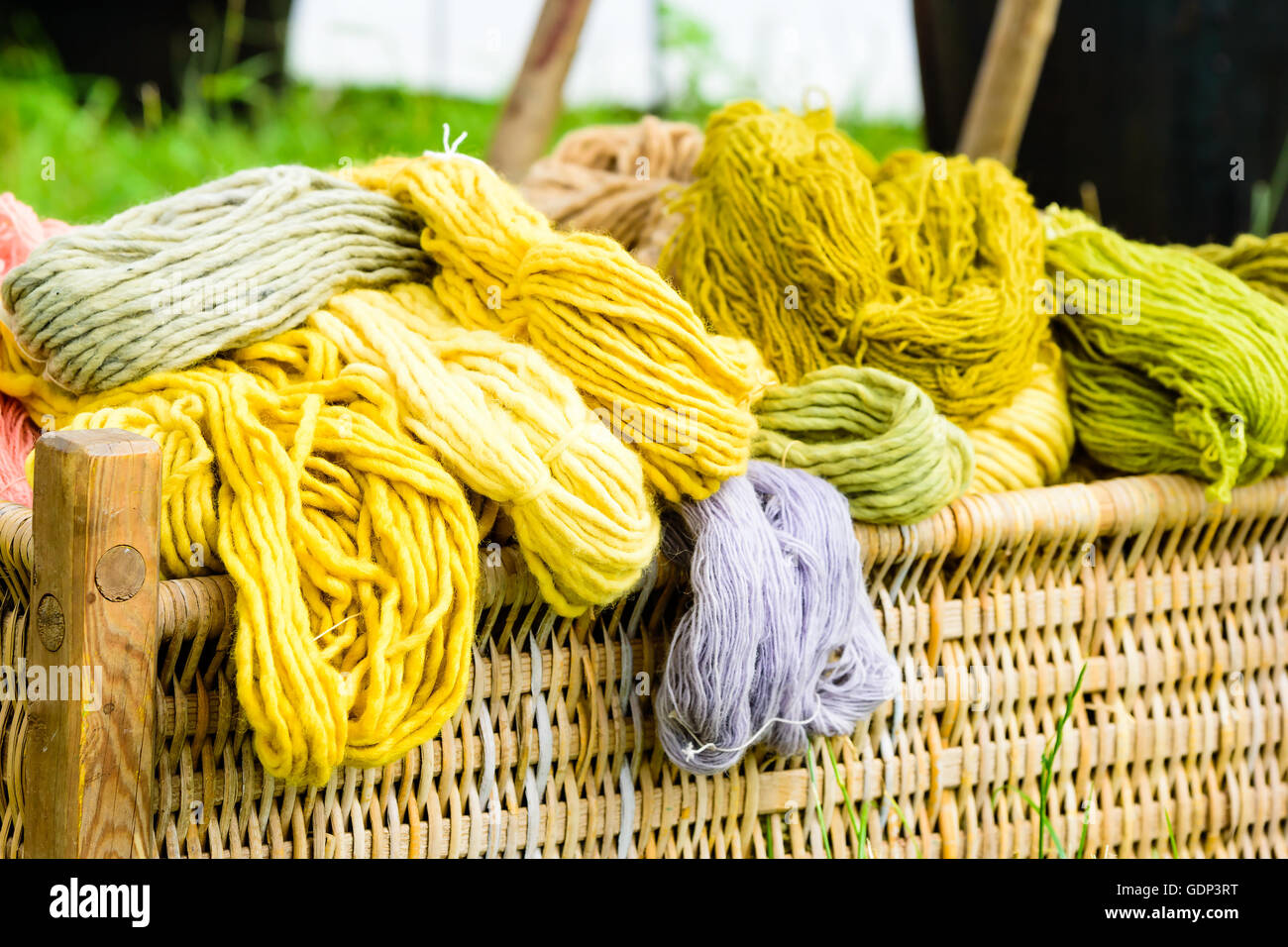 Basket filled with hand dyed yarn in outdoor environment Stock Photo