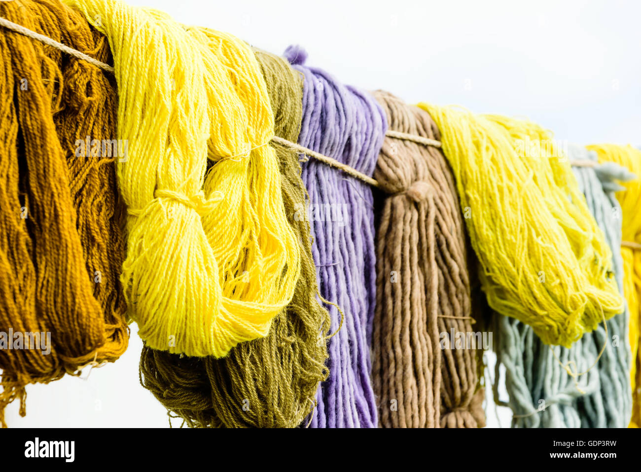 Yarn White Rope Look In Hand dyed yarn hanging from ropes with white tent in background Stock ...