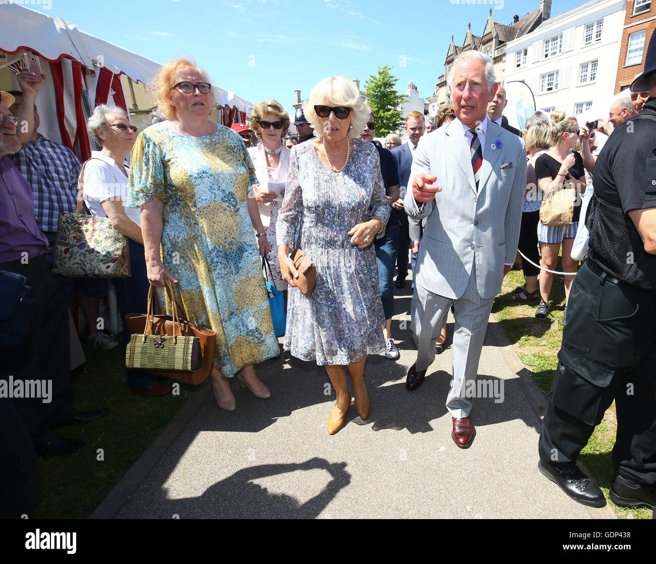 The Prince of Wales (right) and Duchess of Cornwall (centre) tour the Taste of the West's 25th anniversary Food Fair in the grounds of Exeter Cathedral on the second day of their annual visit to the South West. Stock Photo