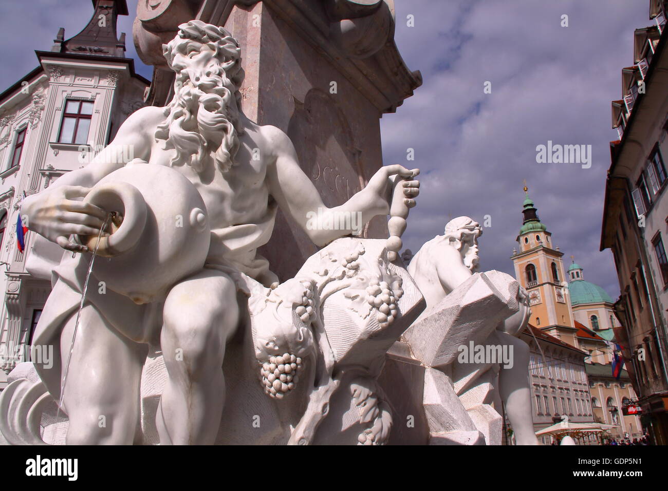 The Fountain of three carniolan rivers (Robba Fountain) with St Nicholas Church in the background, Ljubljana, Slovenia Stock Photo