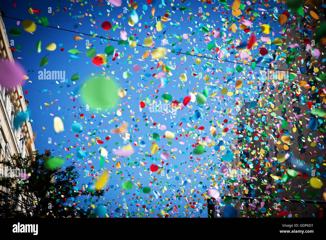 falling confetti in the city festival on blue sky background Stock ...
