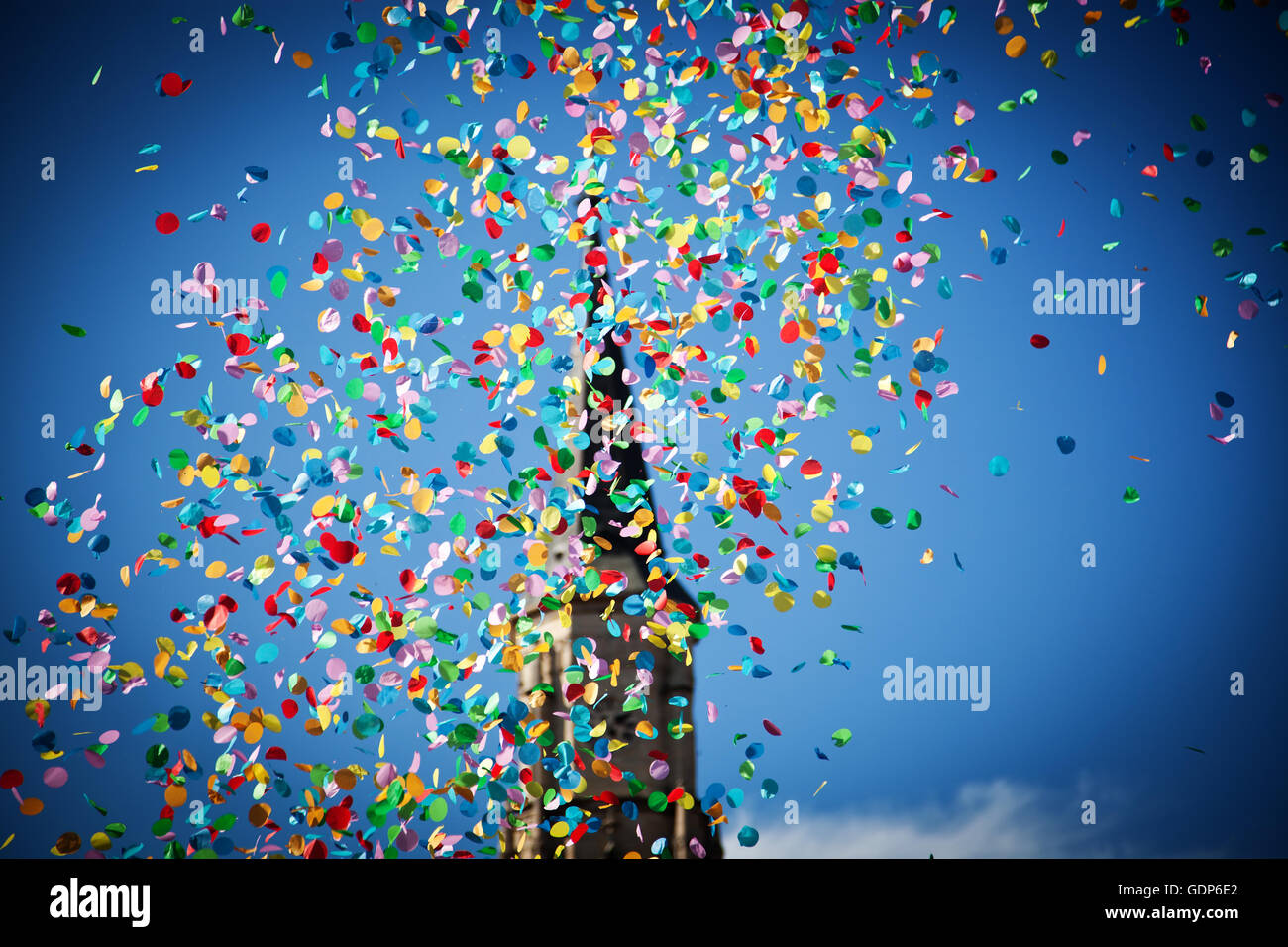 falling confetti in the city festival on blue sky background Stock ...