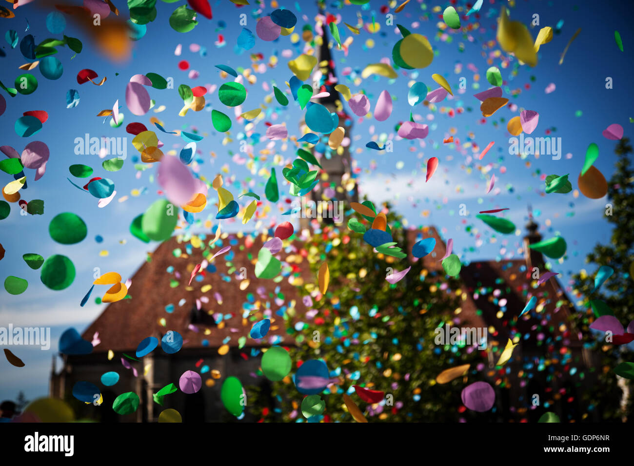 falling confetti in the city festival on blue sky background Stock ...