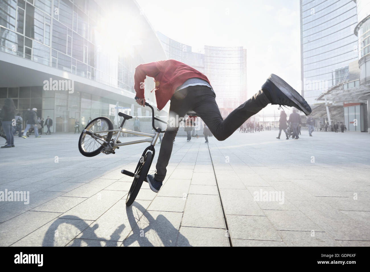 BMX Biker doing stunt in urban area Stock Photo