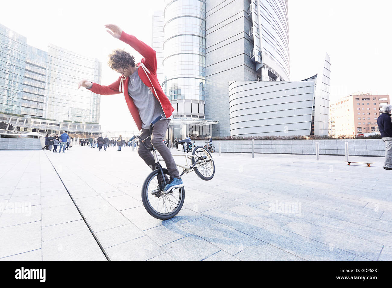 BMX Biker doing stunt in urban area Stock Photo