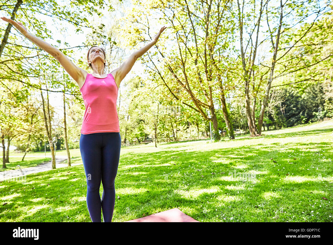 Young Athletic Woman Freely Stretching Her Arms To Nature High-Res