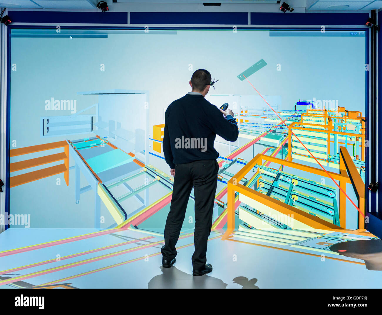 Engineer inspecting factory layout in 3D in virtual reality suite Stock Photo