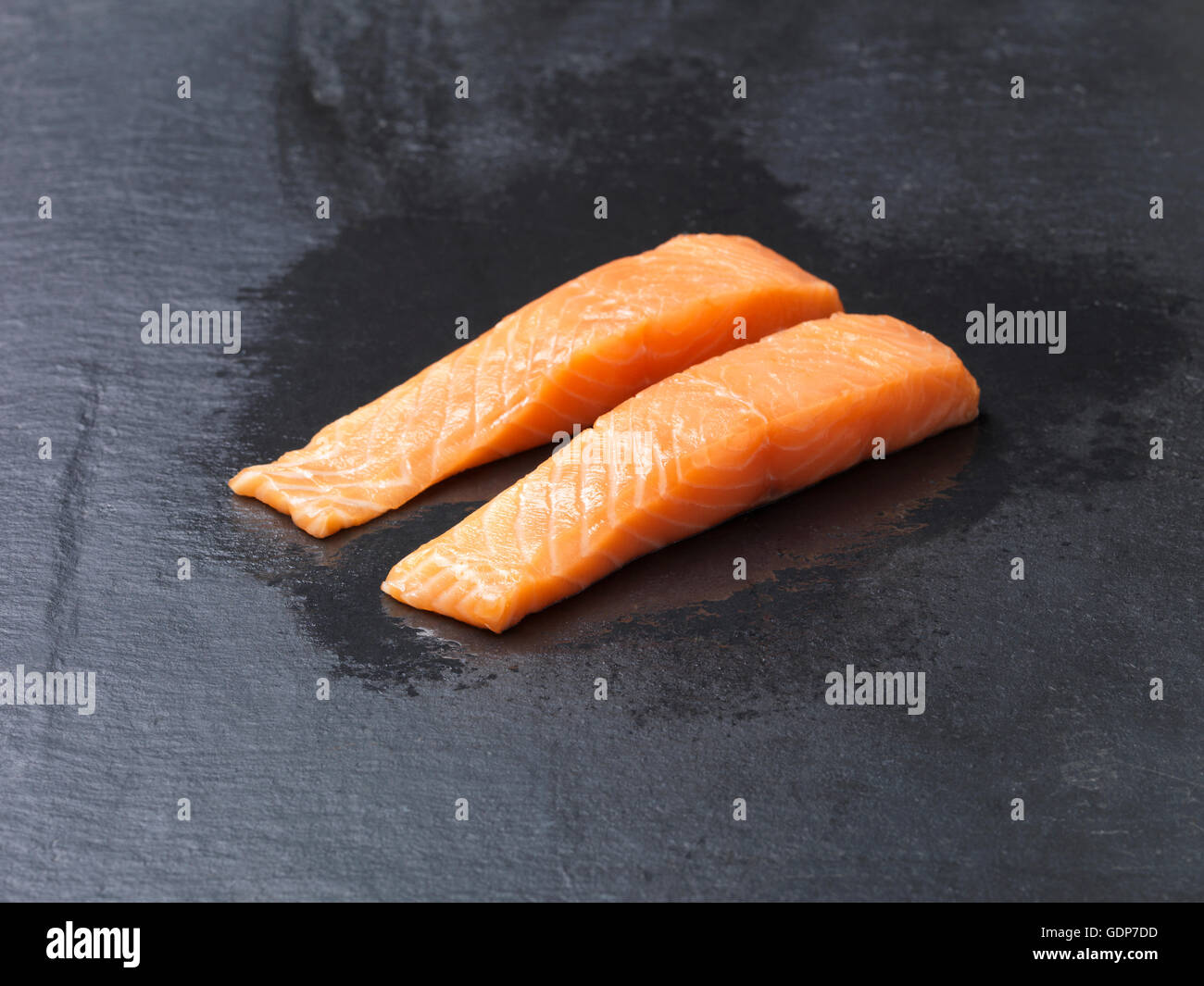 https://c8.alamy.com/comp/GDP7DD/food-raw-fish-two-line-caught-natural-salmon-fillets-on-slate-GDP7DD.jpg