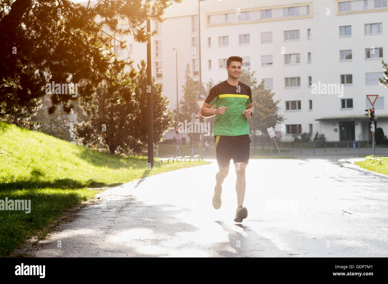 Young athlete jogging in park Stock Photo