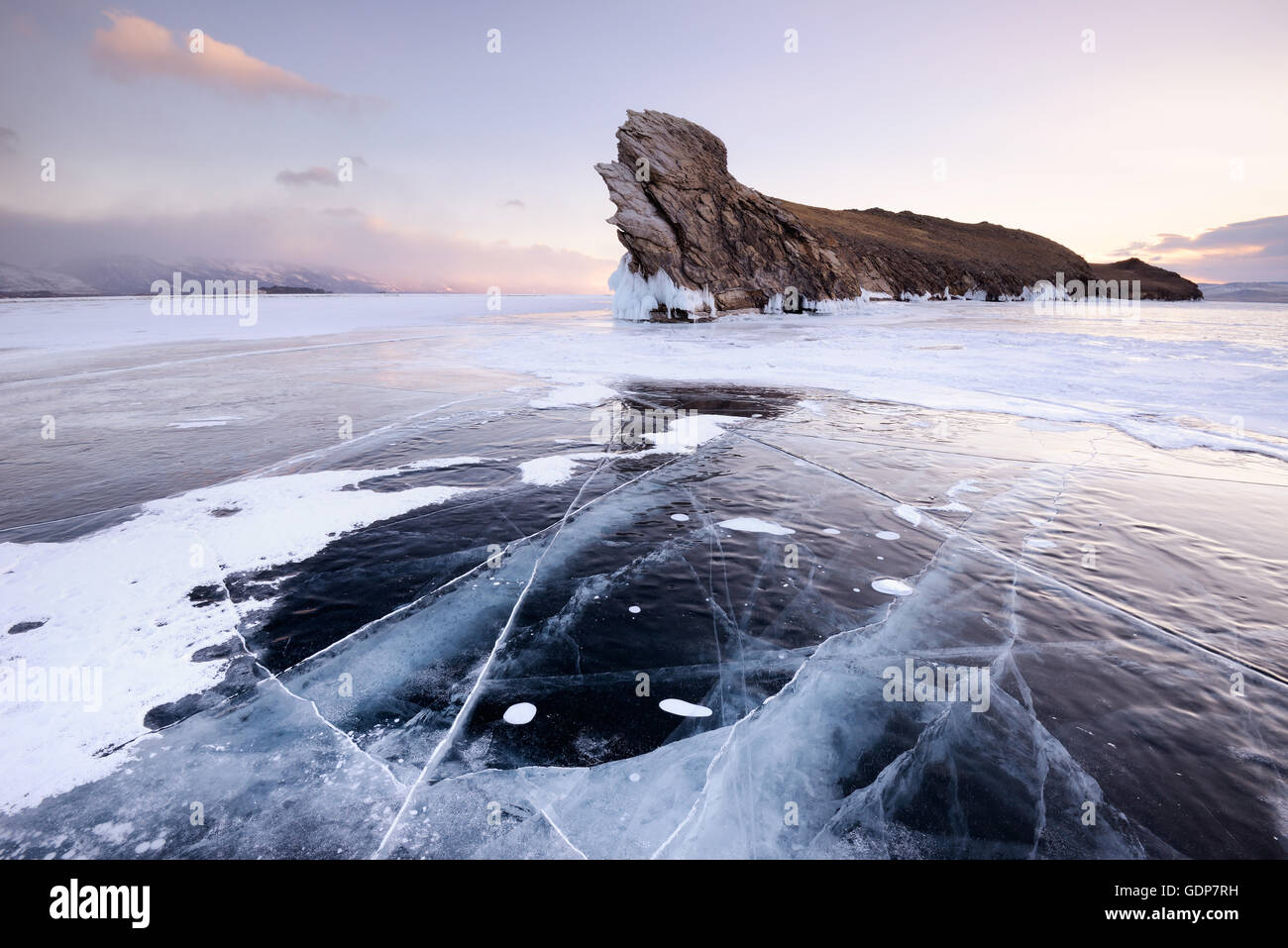 Frozen ice and Ogoy Island on Baikal Lake, Olkhon Island, Siberia, Russia Stock Photo