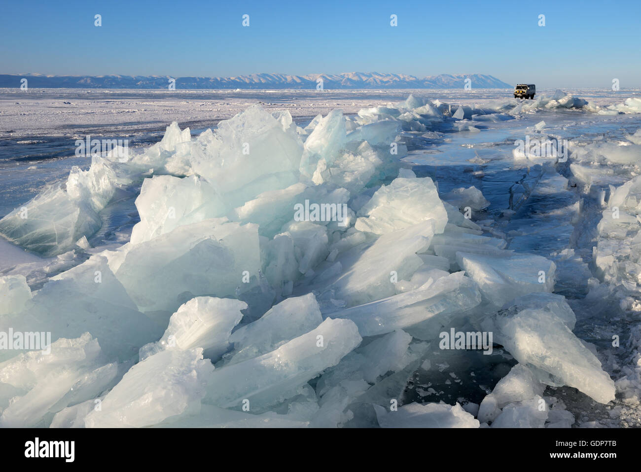 Broken ice and off road tourist vehicle, Baikal Lake, Olkhon Island, Siberia, Russia Stock Photo