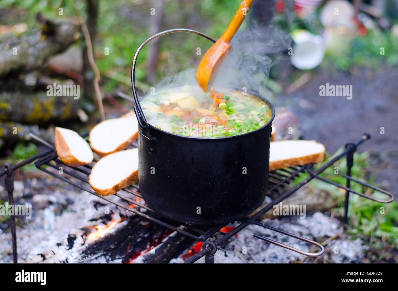 The cooking of soup on the fire on the camping Stock Photo Alamy
