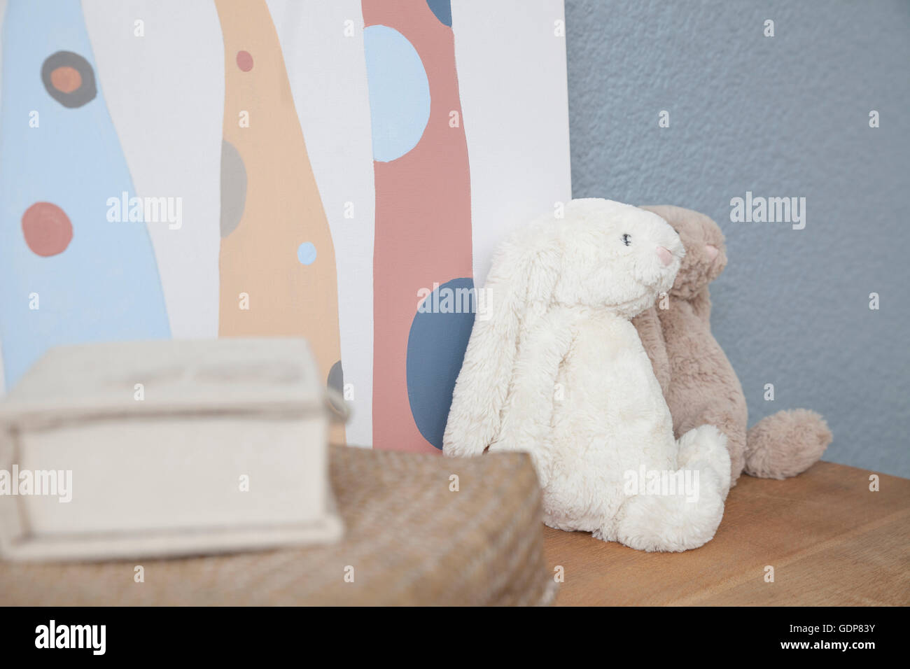 Soft toys on chest of drawers in baby's nursery Stock Photo