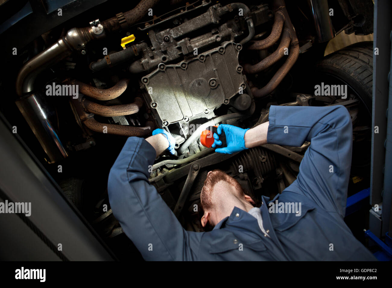 Male Mechanic Holding Torch Looking Under Car Stock Photo Alamy