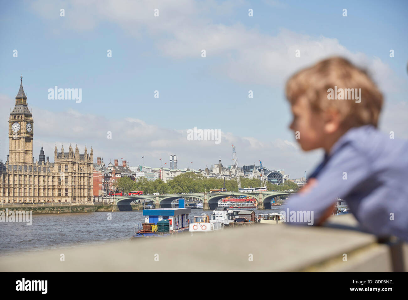 Boy looking at view of river thames Stock Photo