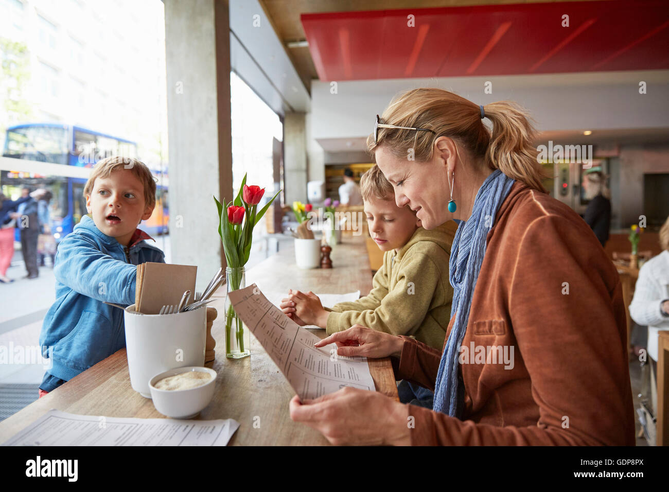 Mother and son at cafe looking at menu Stock Photo