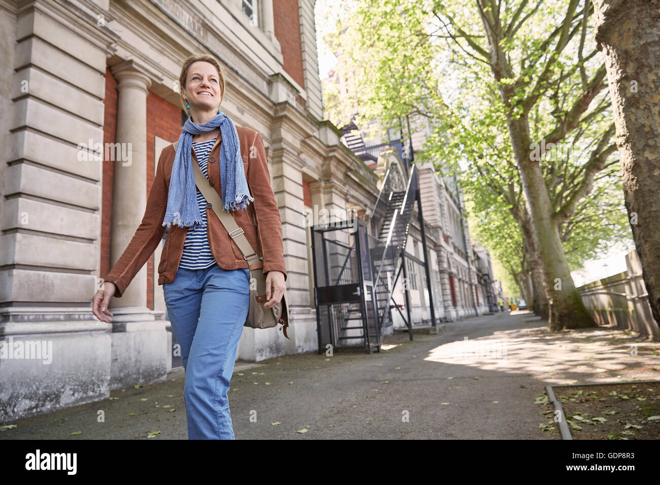 Mature woman walking on street hi-res stock photography and images - Alamy