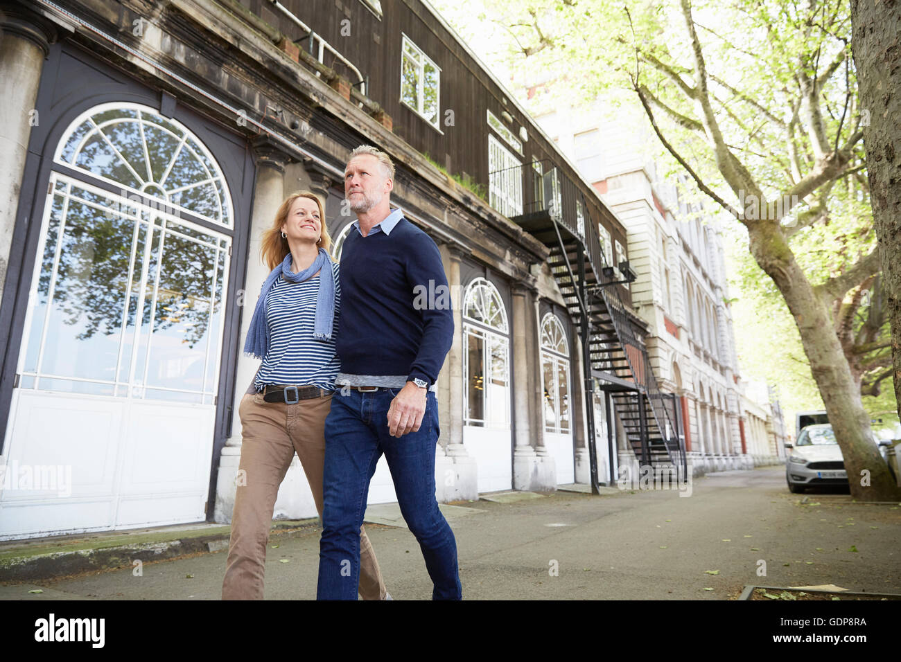 Couple walking down street together Stock Photo