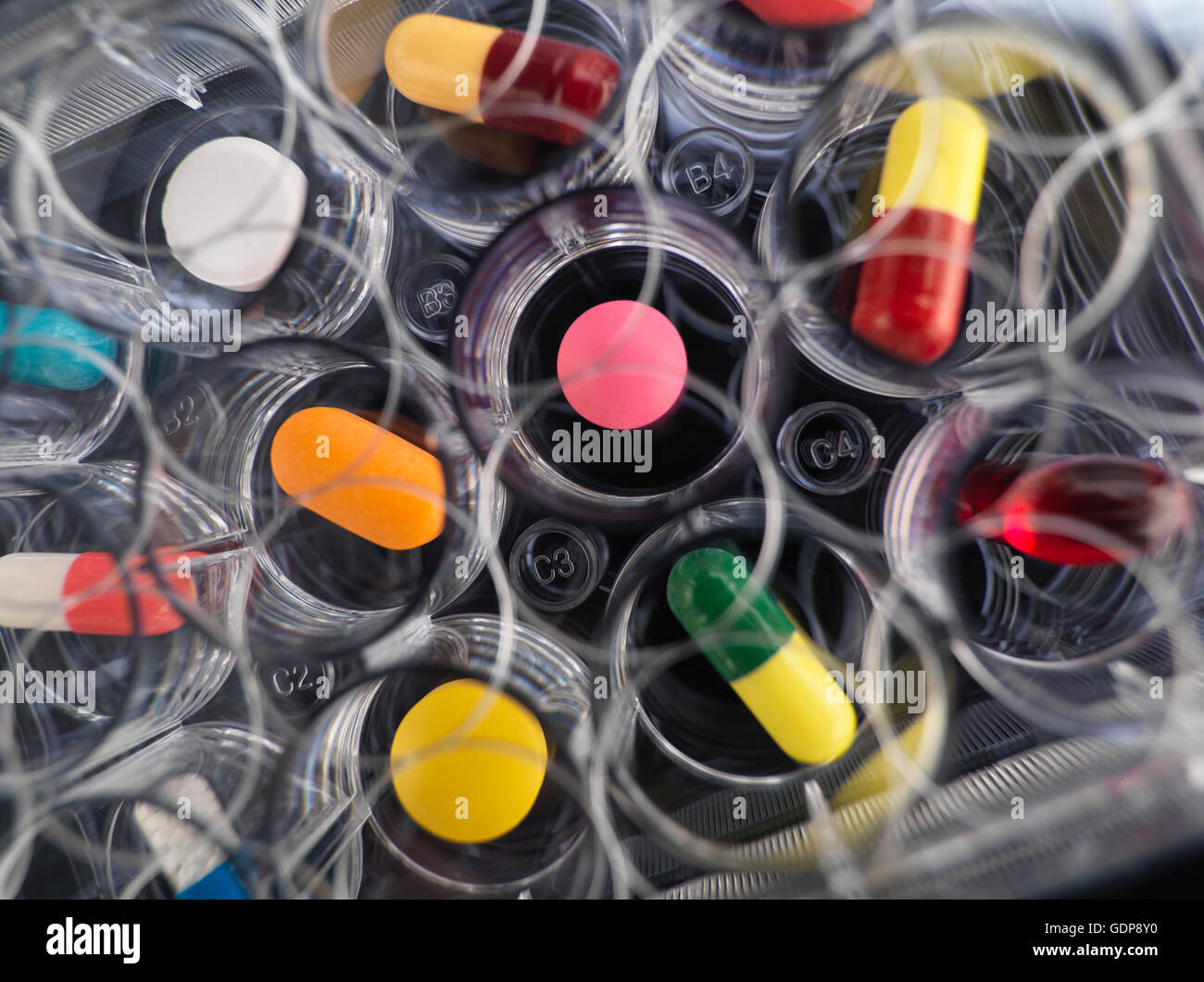 Pharmaceutical research, overhead close up of  variety of medical drugs in a multi well tray for laboratory testing Stock Photo