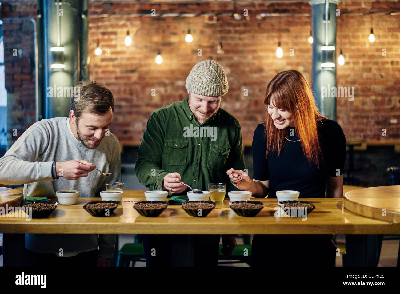 Coffee shop team tasting bowls of coffee and coffee beans Stock Photo