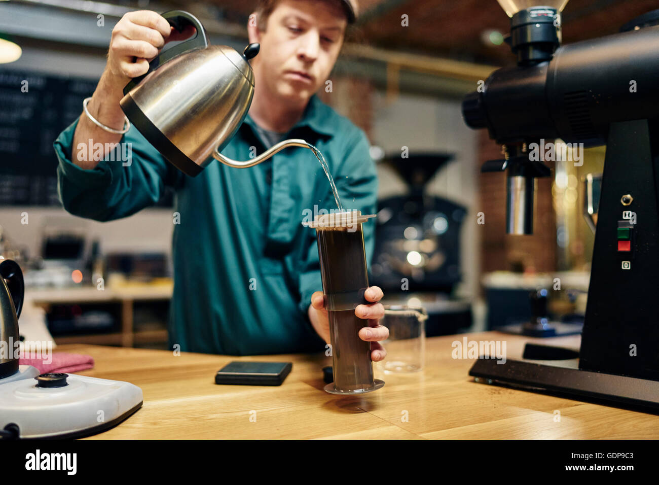 Male barista preparing coffee in coffee shop Stock Photo Alamy