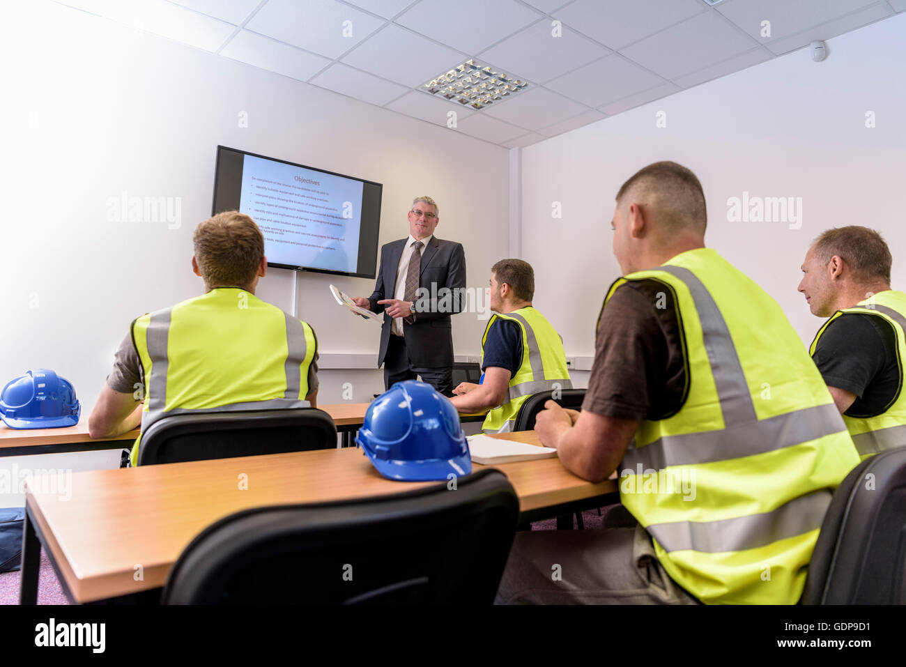 Apprentice builders in presentation in training facility Stock Photo