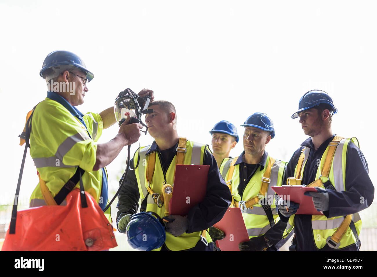 Apprentice builders learning about specialist equipment in training facility Stock Photo
