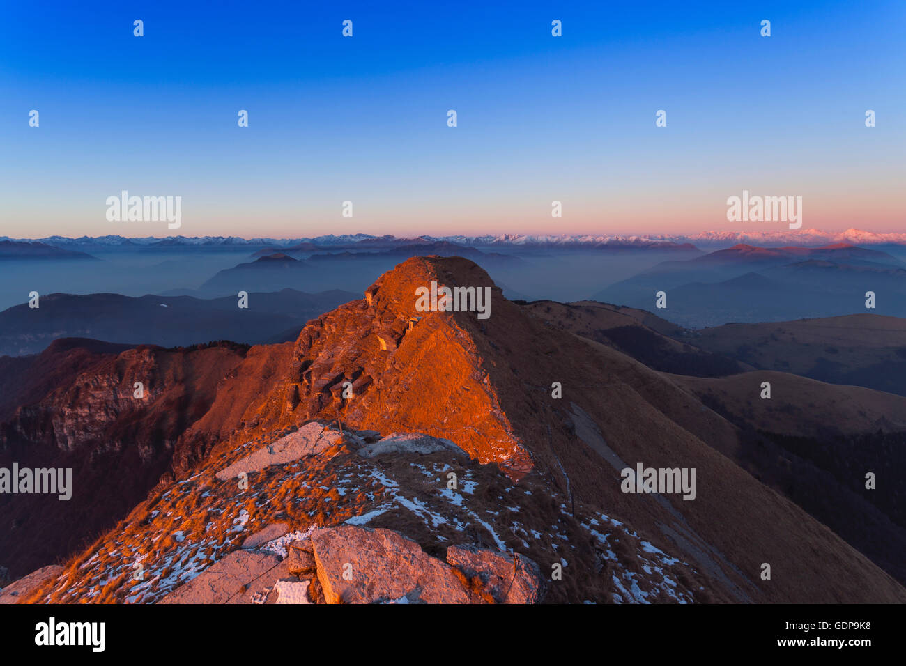 Mountain landscape with distant snow capped mountains, Monte Generoso,Ticino, Switzerland Stock Photo