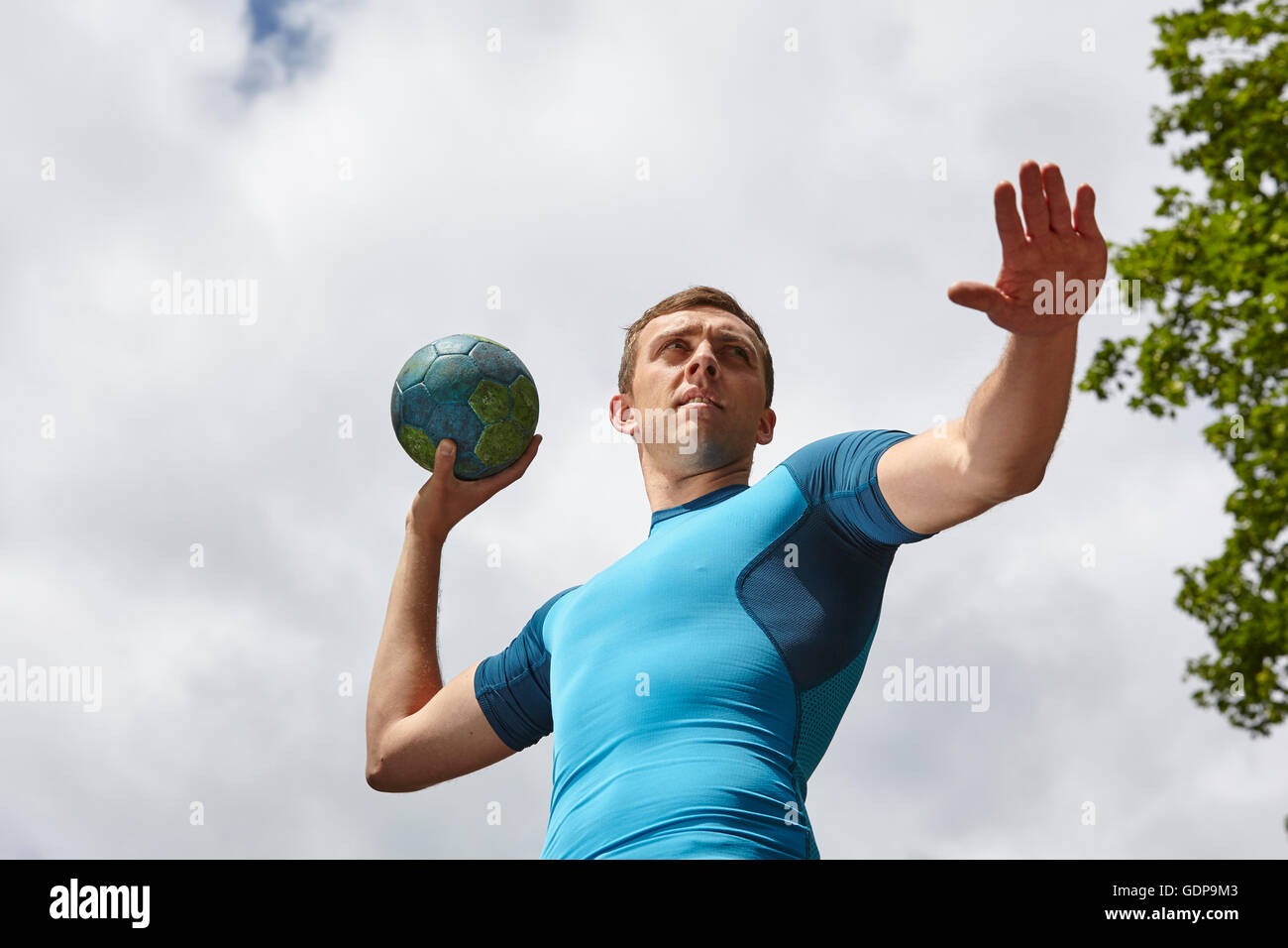 Low angle view of young male handball player preparing to throw ball Stock Photo