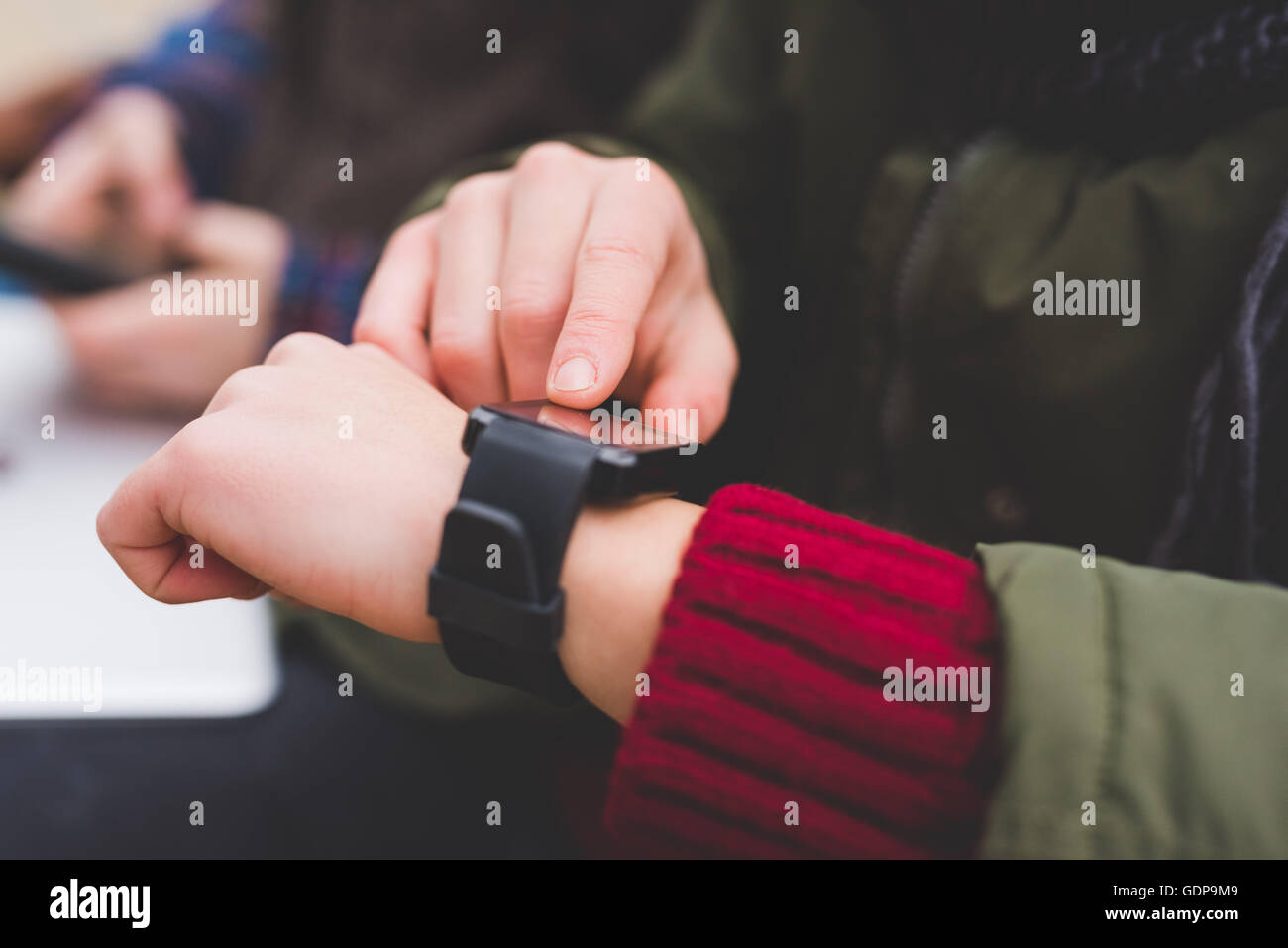 Young woman using smartwatch, outdoors Stock Photo