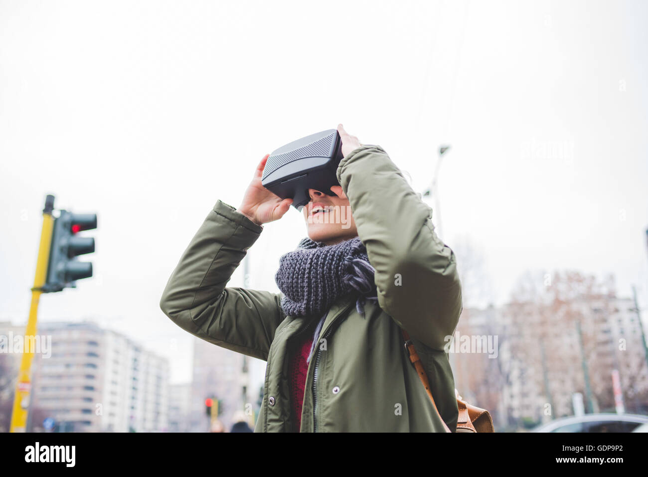 Young woman outdoors, wearing virtual reality headset Stock Photo Alamy