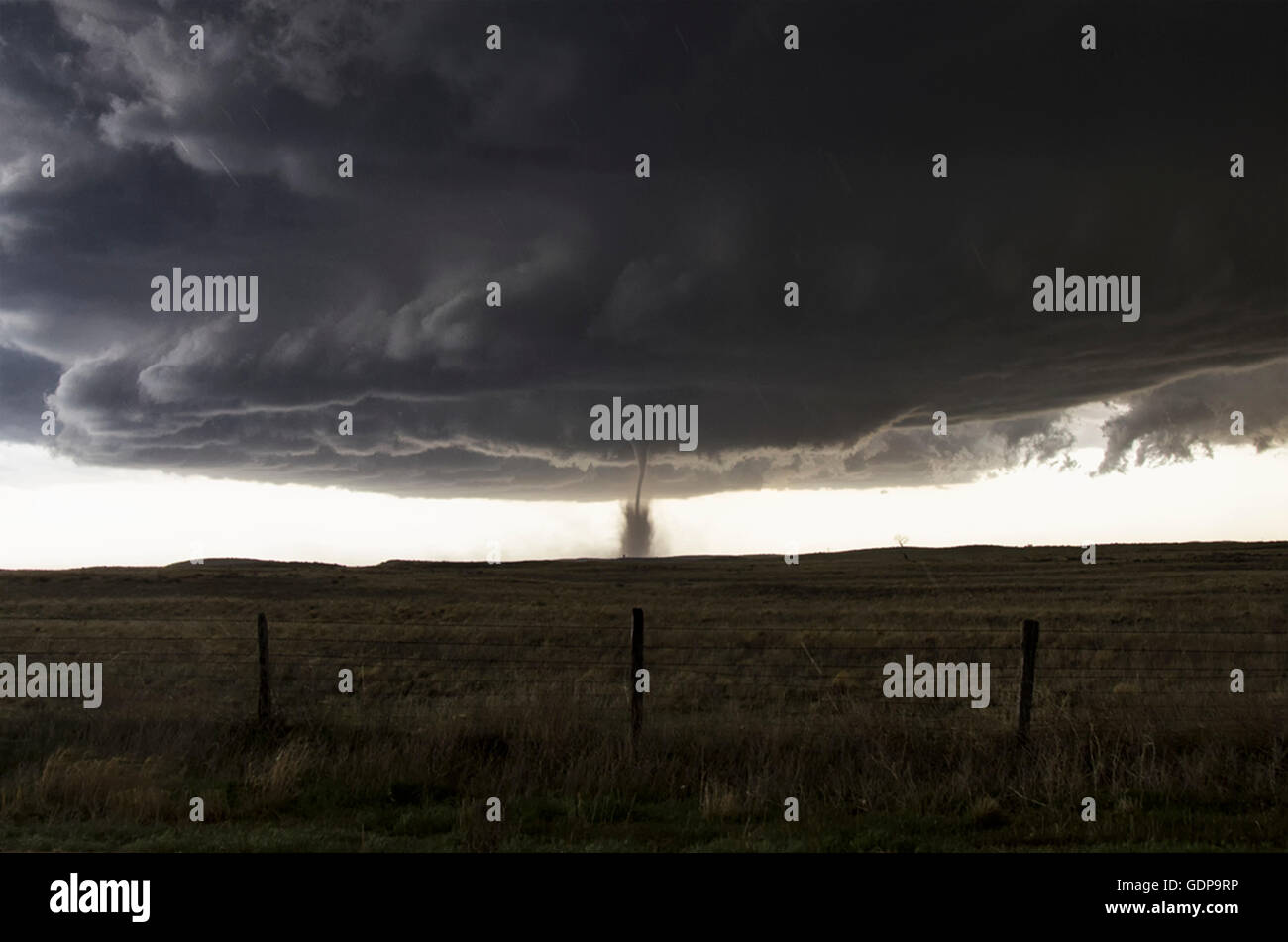 Full structure of tornado, parent wall cloud and storm Stock Photo