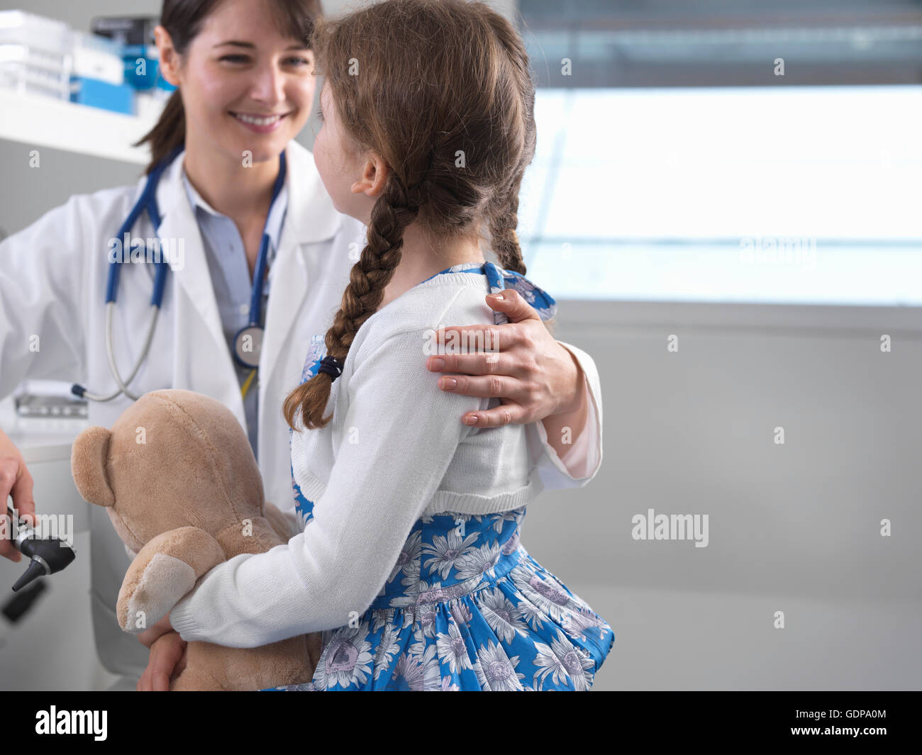 Pediatrician consulting with girl Stock Photo