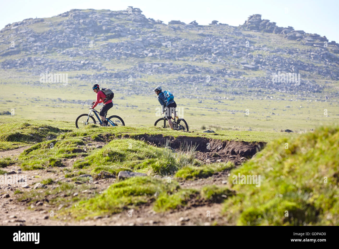 Cyclists cycling on hillside Stock Photo