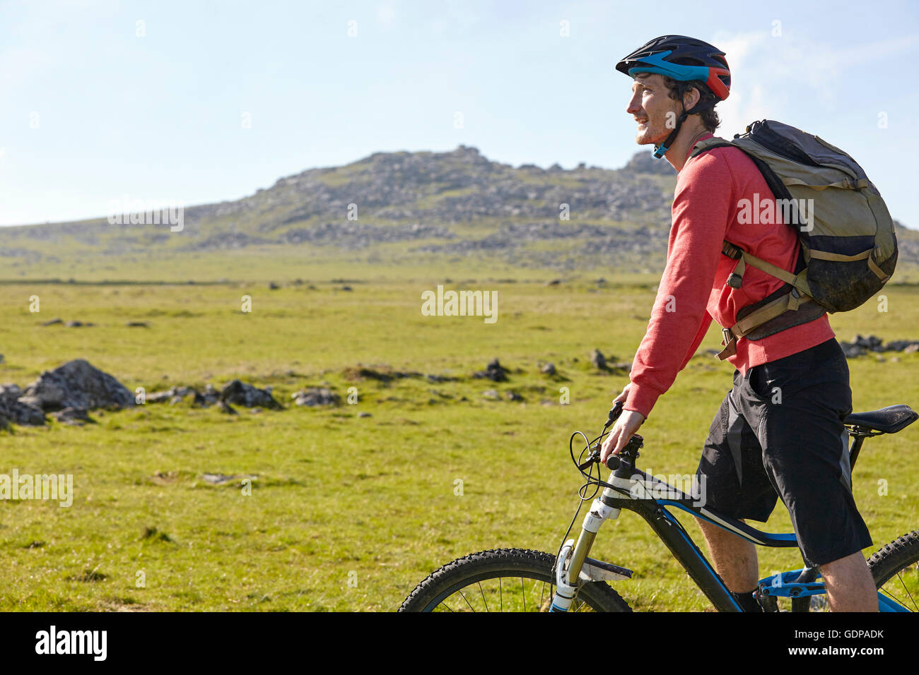 Side view of cyclist cycling on hillside Stock Photo