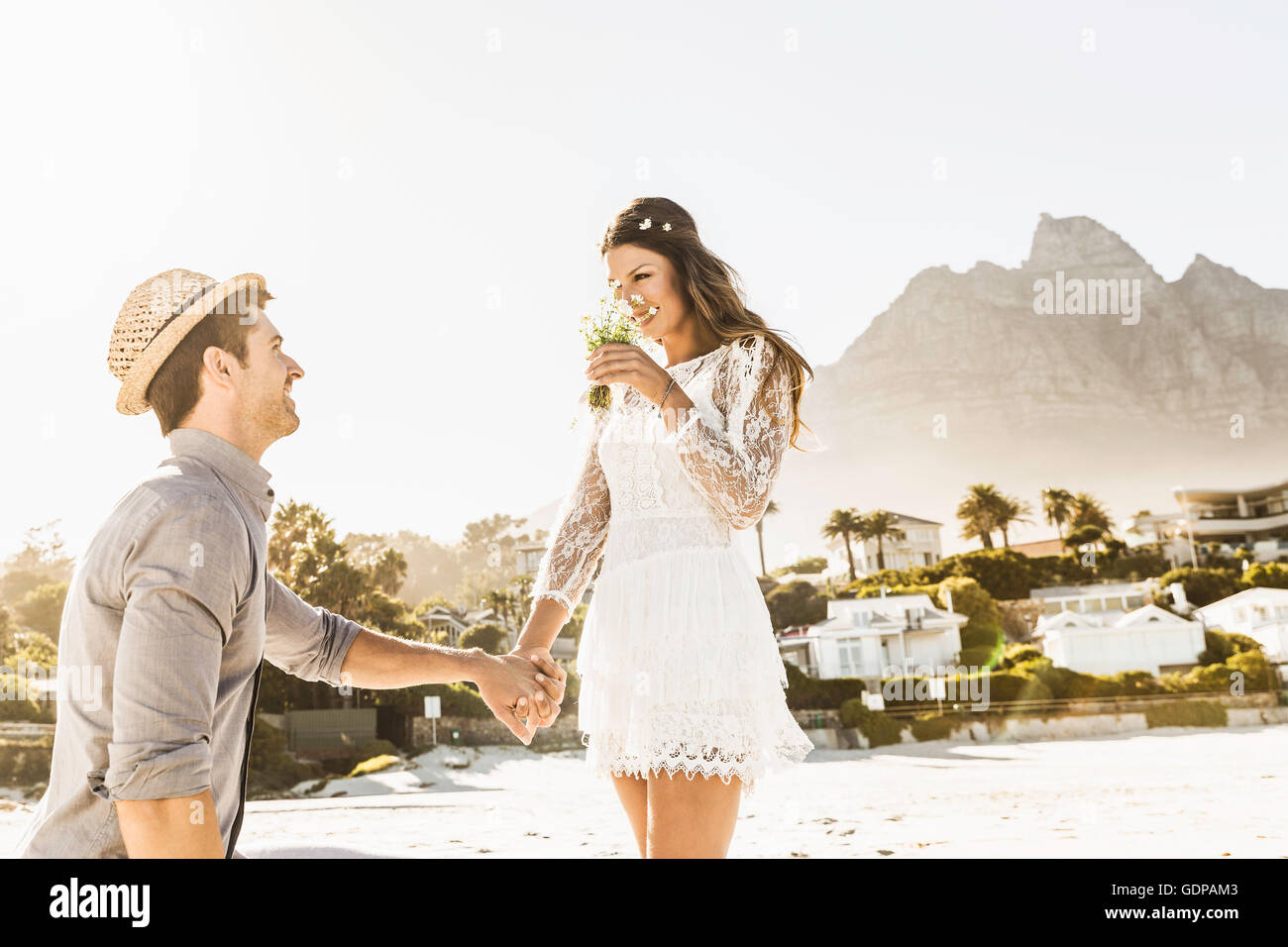 Man on one knee proposing to girlfriend on beach, Cape Town, South Africa Stock Photo