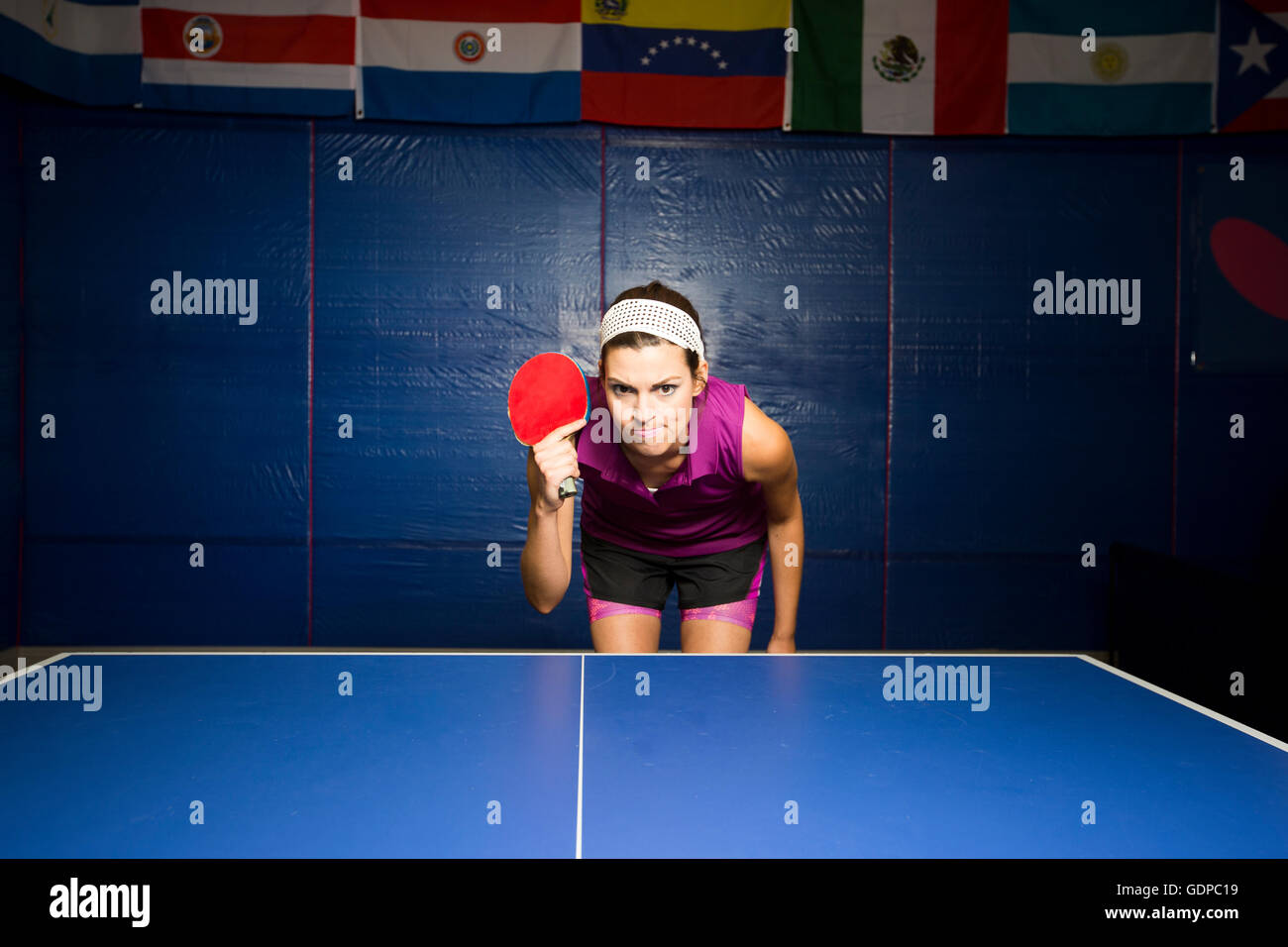 Table tennis player with bat bending forward at table Stock Photo Alamy