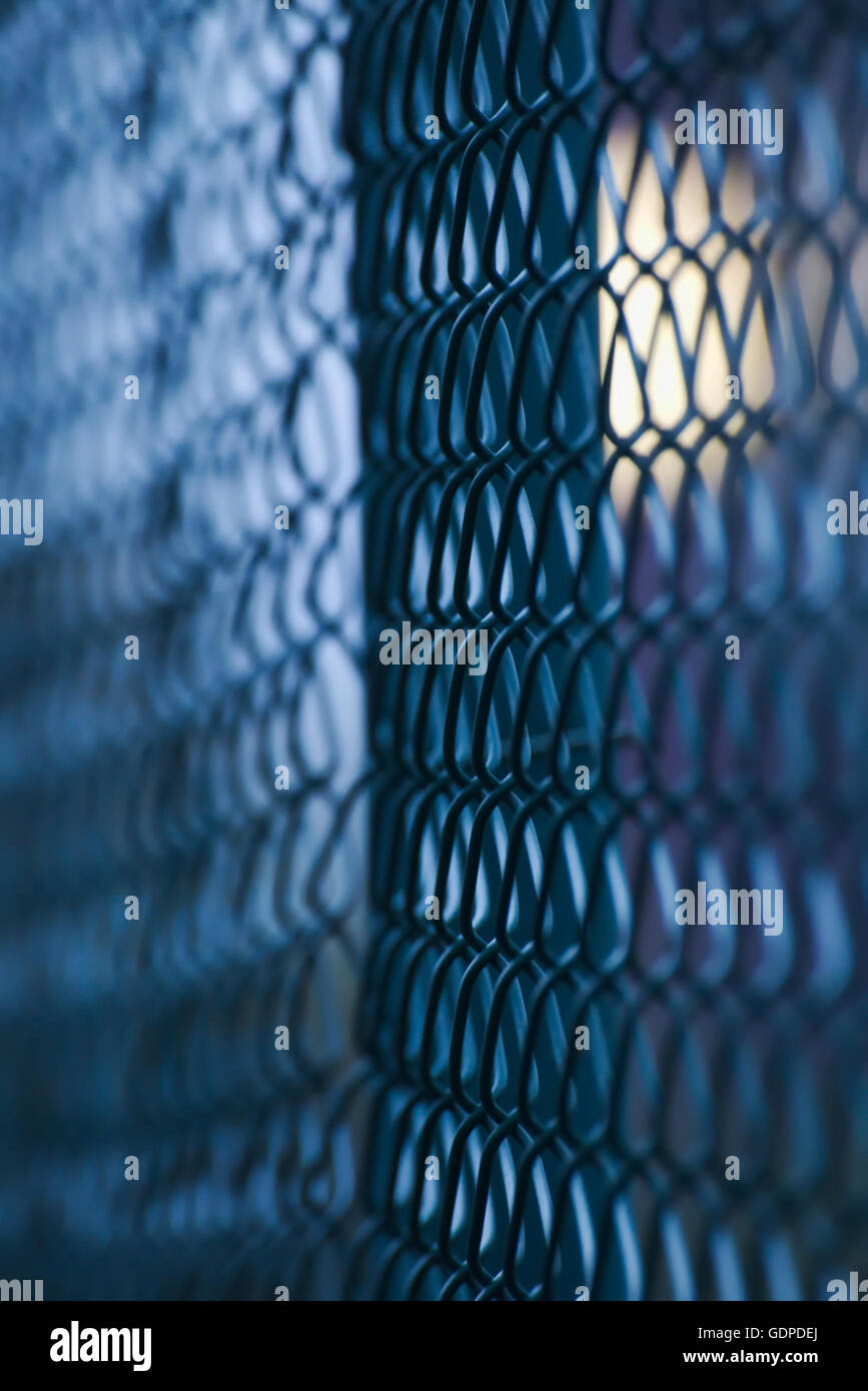 Abstract shot of a green wire mesh fence with defocusing effect and ...