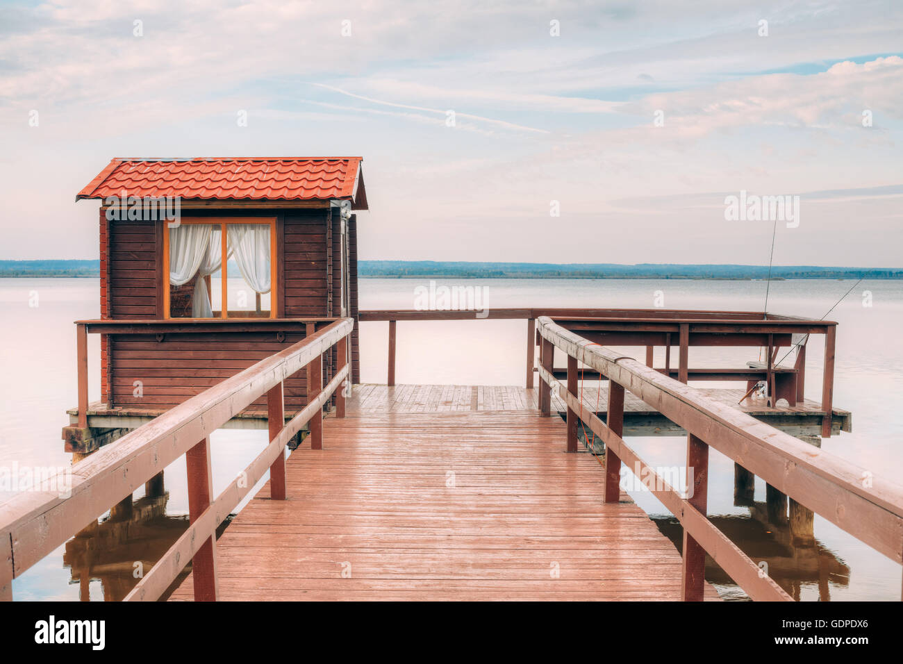 https://c8.alamy.com/comp/GDPDX6/old-wooden-pier-for-fishing-small-house-shed-and-beautiful-lake-or-GDPDX6.jpg
