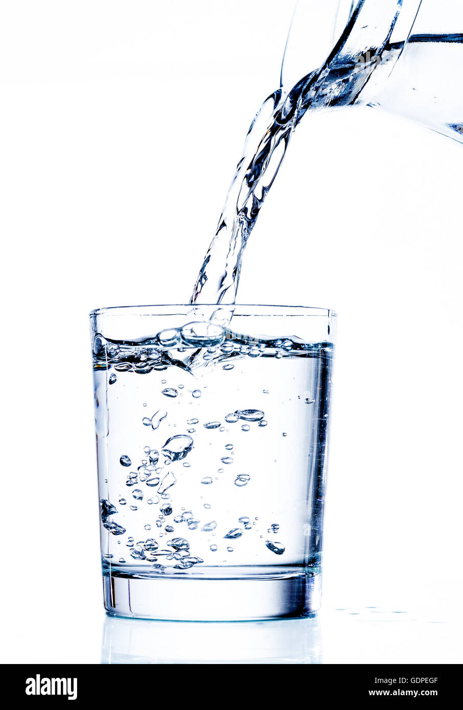 Filling glass with water from jug Stock Photo