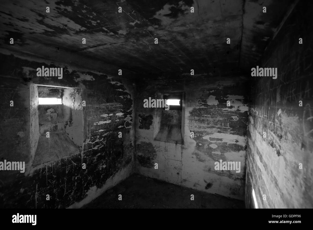 View in a small confined room in an old WWII bunker near Lostau, Saxony-Anhalt, Germany. Black and white image. Stock Photo