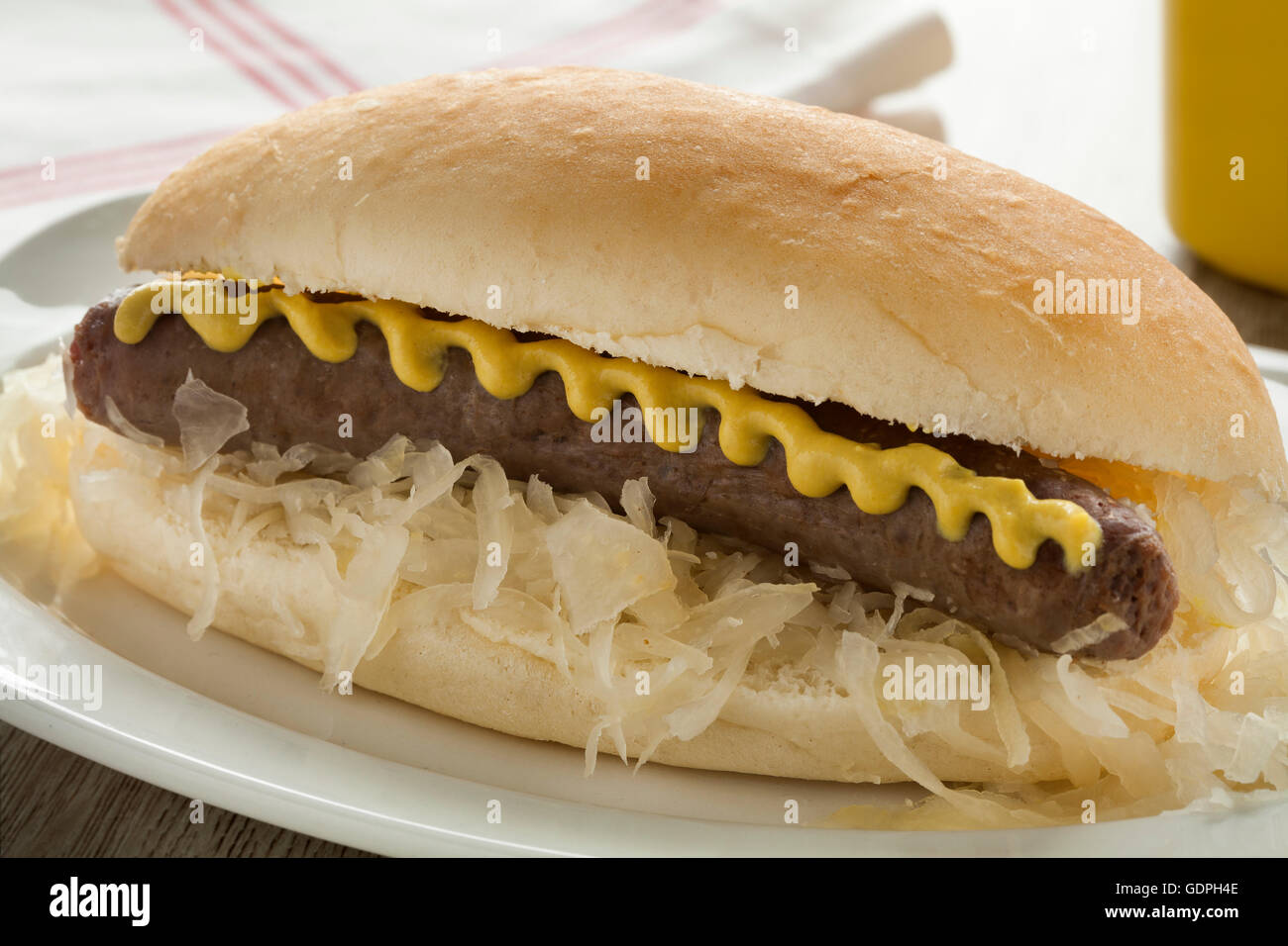 White bun with sauerkraut, sausage and mustard close up Stock Photo