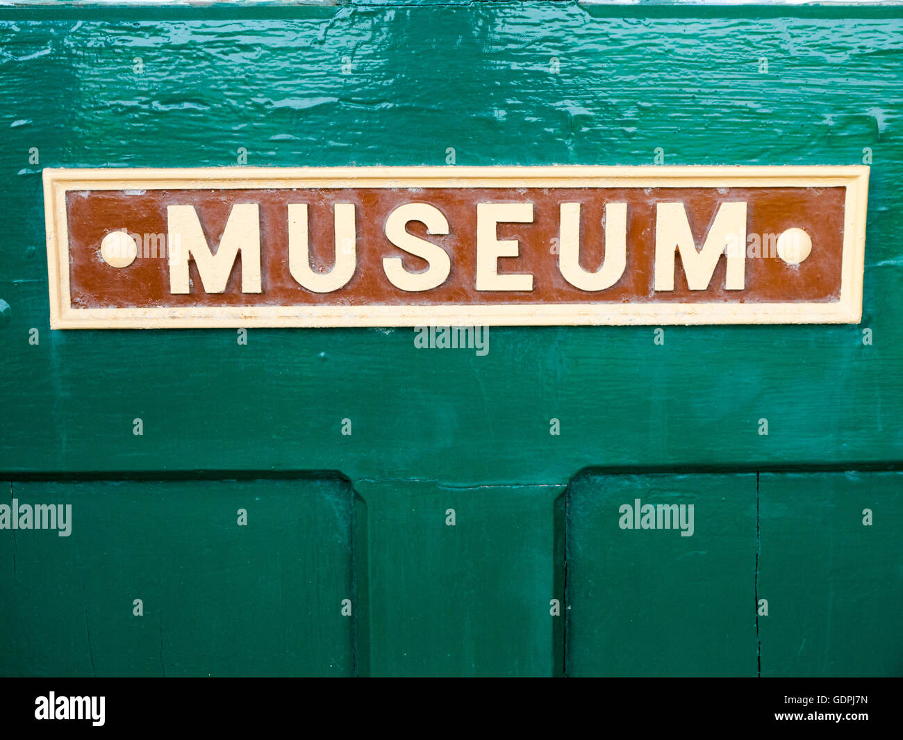 Museum sign on green door UK Stock Photo