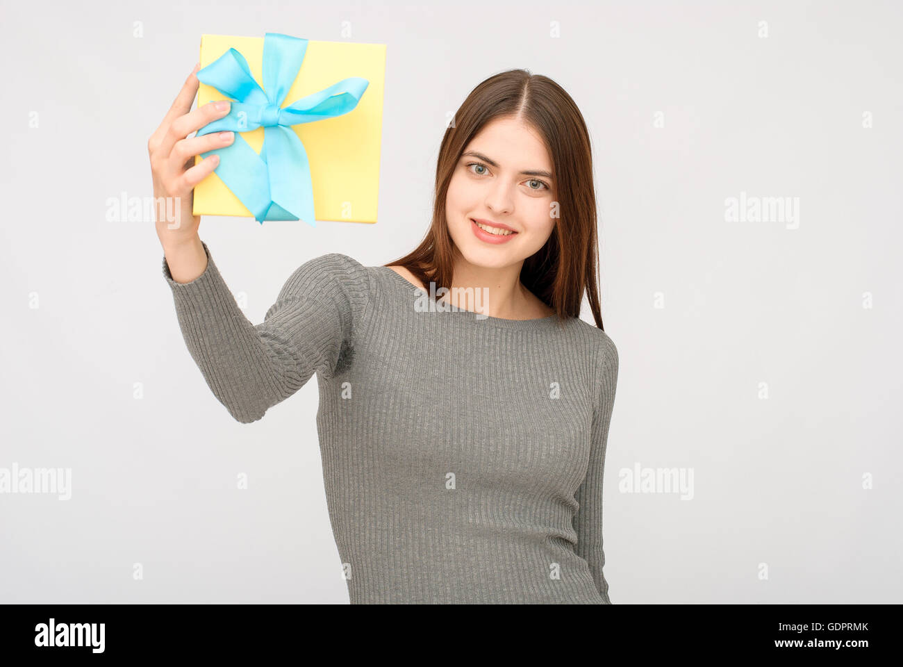 Young woman portrait holding gift Stock Photo - Alamy