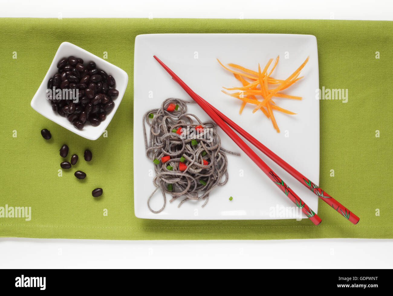 Black Bean and Black Bean Spaghetti garnished with Carrots Stock Photo